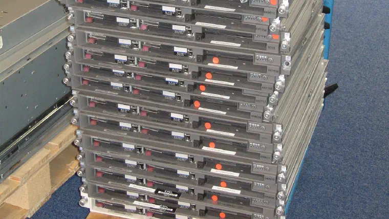 A stack of decommissioned rack servers on a trolley, ready for scrapping